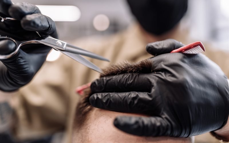 Men's haircut in a barbershop. Styling and hair care. Beauty salon.